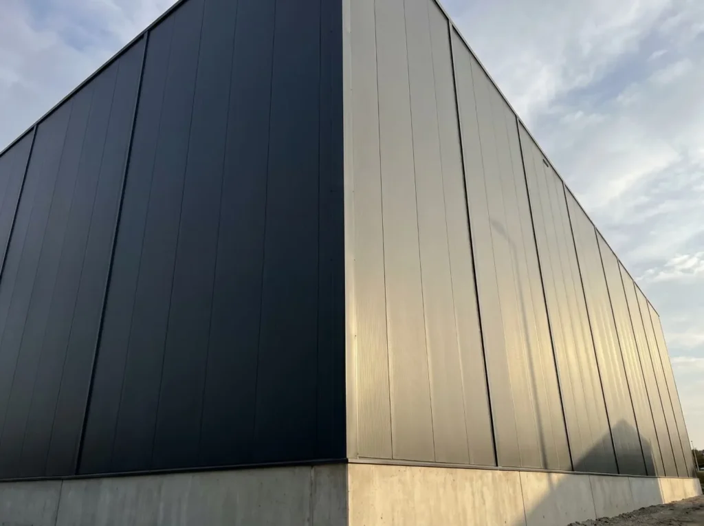 Massive industrial warehouse exterior featuring a robust, continuous YG Panels insulated panel envelope