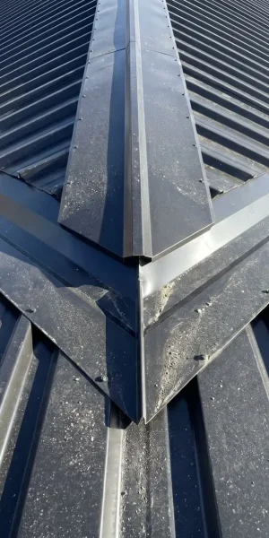 Detailed view of YG Panels metal roof valley flashing and matched trim, ensuring perfect water performance and finished look.