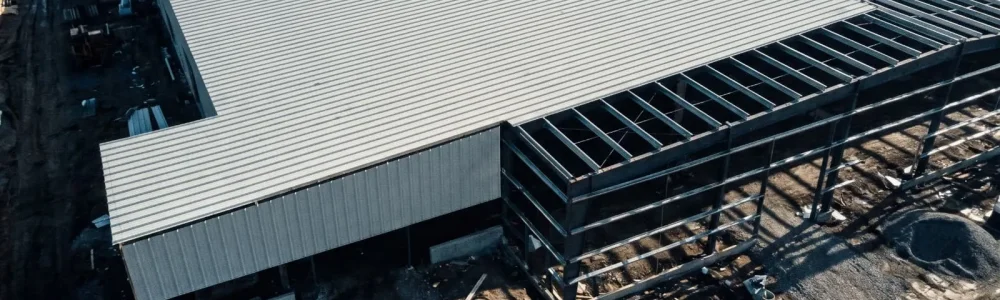 Large scale industrial workshop utilizing trapezoidal metal roof sheets for practical and efficient roof area coverage