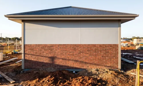 Physical on-site mock-ups comparing different YG Panels roof-wall combinations, including light walls with dark roofs, wood grain finishes, and mixed bric
