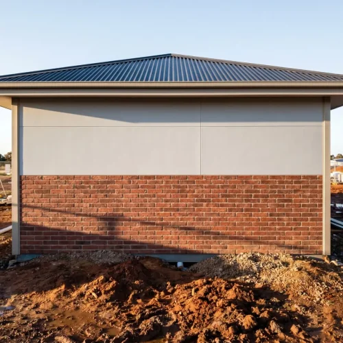Physical on-site mock-ups comparing different YG Panels roof-wall combinations, including light walls with dark roofs, wood grain finishes, and mixed bric